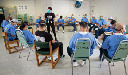 Prison Arts Collective founder and executive director Professor Annie Buckley in dialogue with participants as part of the collaborative arts workshops at Ironwood State Prison. Photo by Peter Merts, June 2022