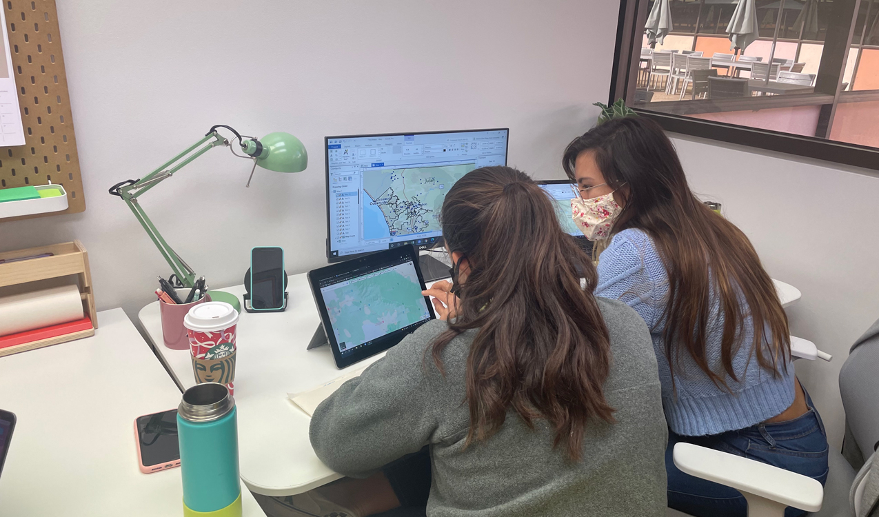 Dr. Madison Swayne (left) and Adriana Rios (right) utilizing ArcGIS Pro mapping software to map San Diego County restrooms. Photo credit: Megan Welsh Carroll.