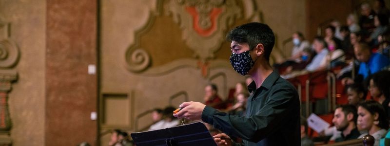 School of Music and Dance student conducts piece at Winter at the Balboa.