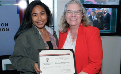 Rianne Magbuhat (left) is presented with the Global Campus Award during the twenty-fourth annual Art and Design Student Award Exhibition on March 3, 2022.