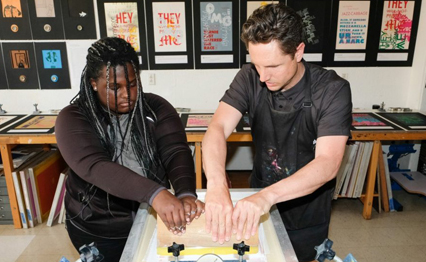 Screen printing professor, Scott Wyss instructing student