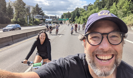 Dr. Bruce Appleyard bicycling on the I-405 Freeway while participating in the annual Providence Bridge Pedal event in Portland, Oregon.