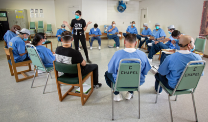 Prison Arts Collective founder and executive director Professor Annie Buckley in dialogue with participants as part of the collaborative arts workshops at Ironwood State Prison Photo by Peter Merts, June 2022
