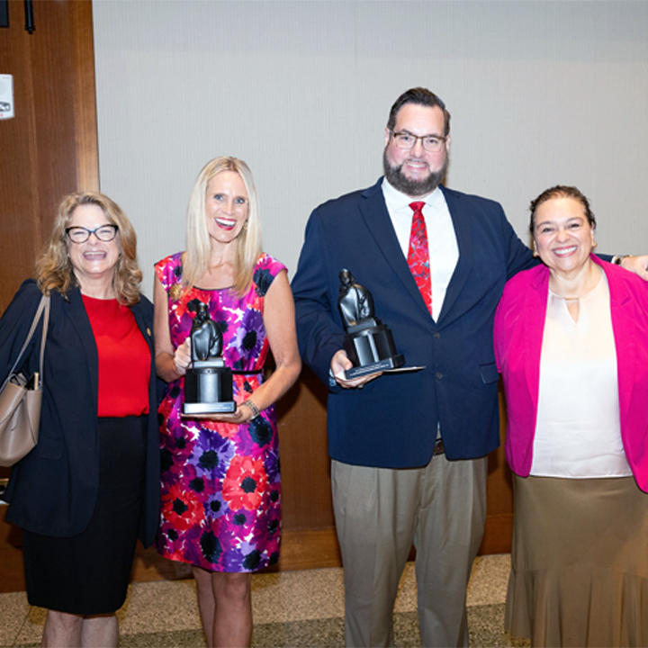 Dr. Kaye Sweetser, second from left, celebrates receiving the SDSU Alumni Association Award at the All-University Convocation alongside colleagues and fellow honorees.