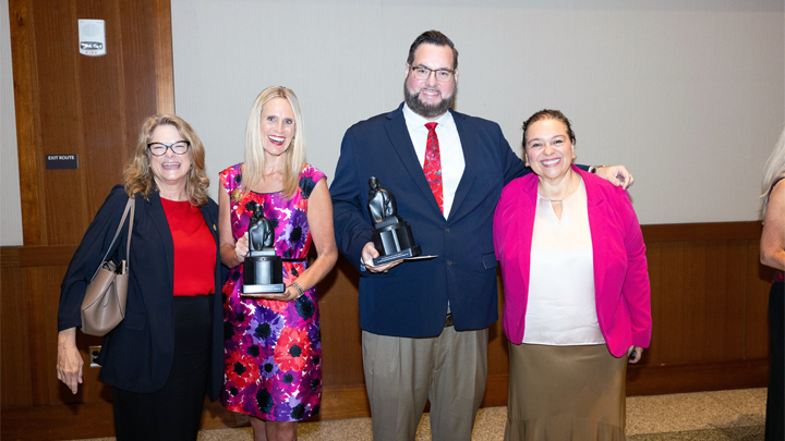 Dr. Kaye Sweetser, second from left, celebrates receiving the SDSU Alumni Association Award at the All-University Convocation alongside colleagues and fellow honorees.