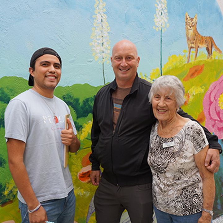Jacob Gallardo, Adam Pine and Patty Bender posed in the outdoor patio of the Uptown Community Service Center.