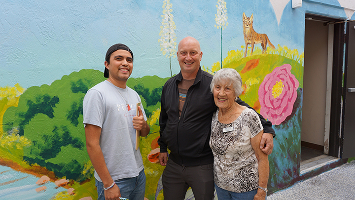Jacob Gallardo, Adam Pine and Patty Bender posed in the outdoor patio of the Uptown Community Service Center.