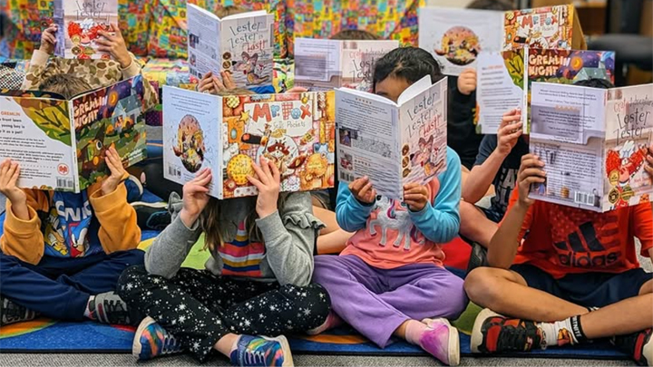 photo of children holding up books