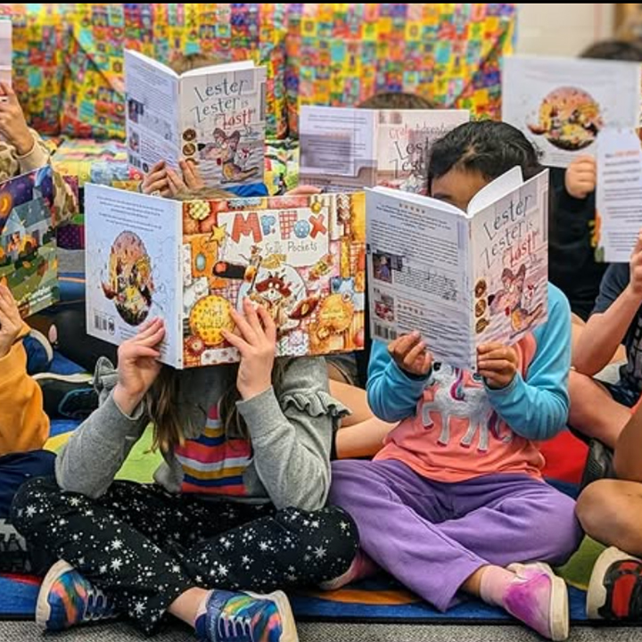 photo of children holding up books