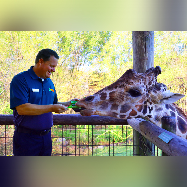 Rick with Jelani, a male giraffe, at the Fort Wayne Zoo in 2021.